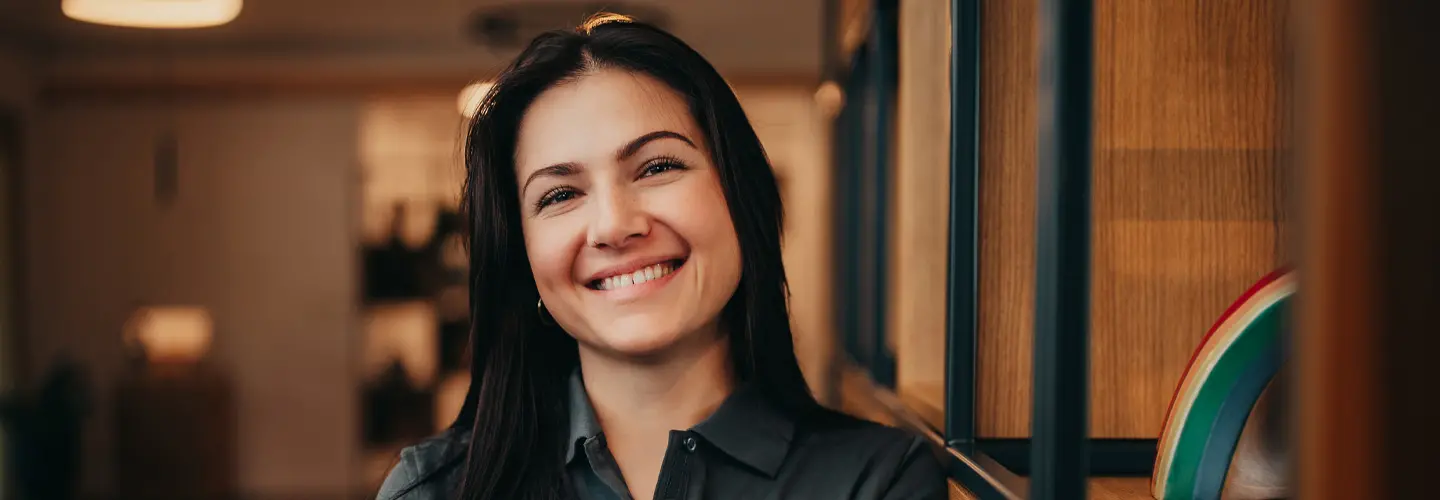 Frau steht an einem Regal für Urnen in einem großen Kundenraum.